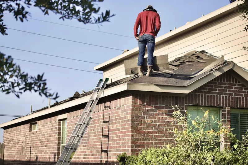 Professional roofer working on a residential roof in Exeter